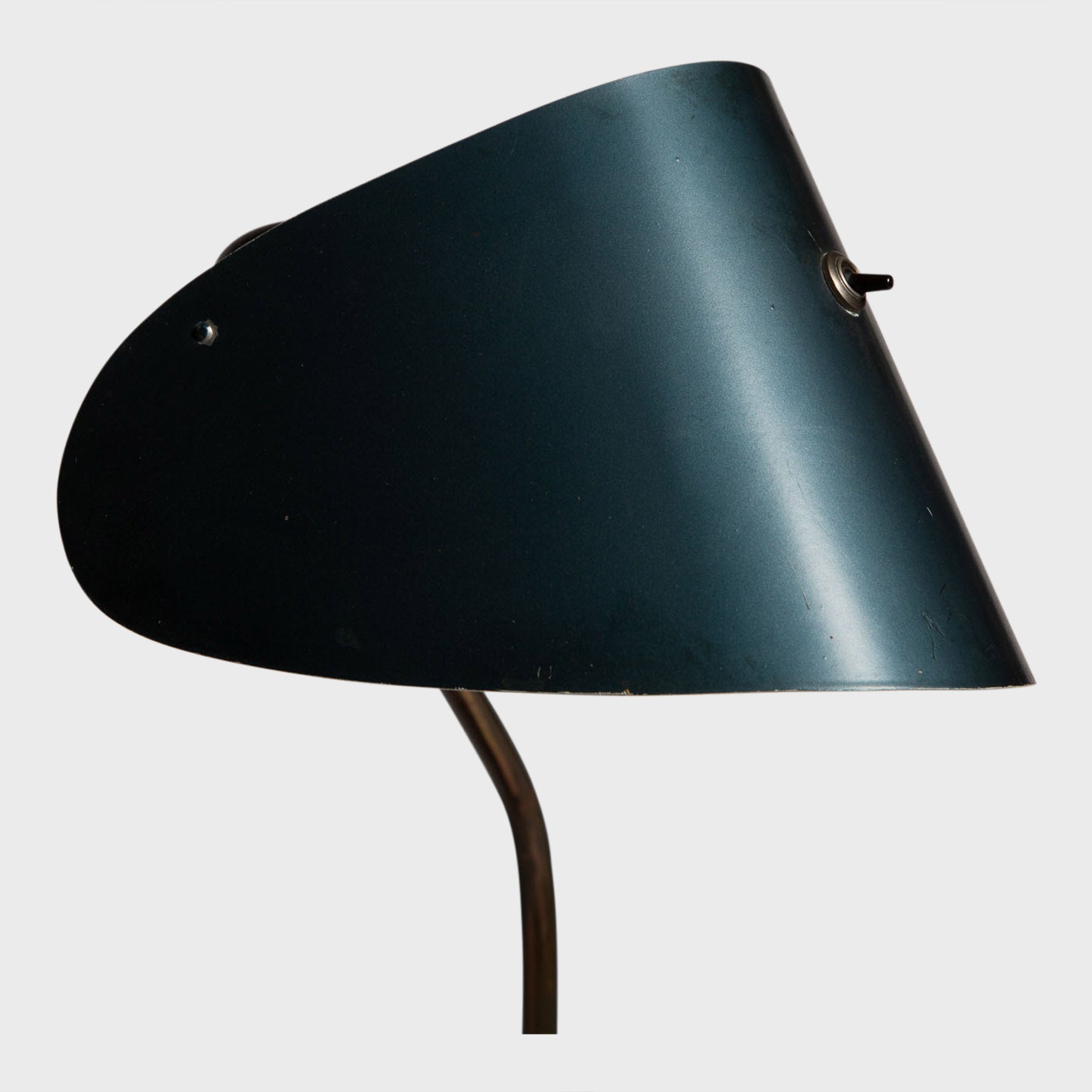 black curved metal desk lamp close up