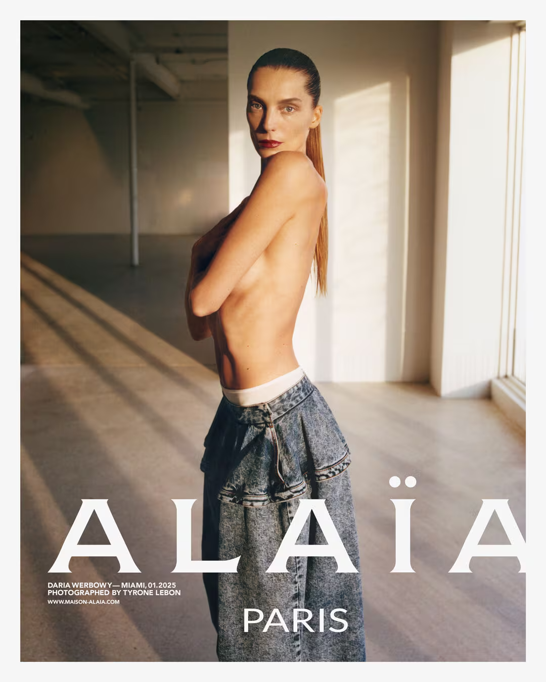 Model wearing Alai jeans with brand name displayed.