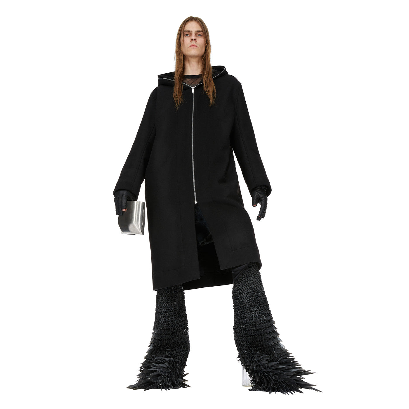 Person wearing a long black Rick Owens coat with unique footwear on a white background