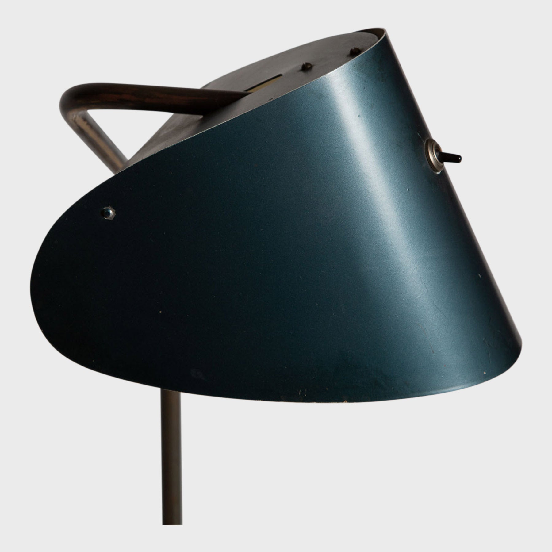 black curved metal desk lamp close up